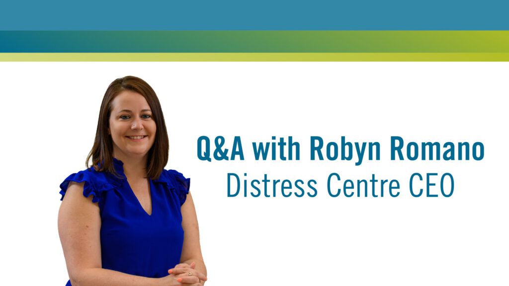 img text: Q&A with Robyn Romano - Distress Centre CEO img des: blue text on a white background with a head and shoulders photo of Robyn beside the text. Top border shows blue and green gradient lines