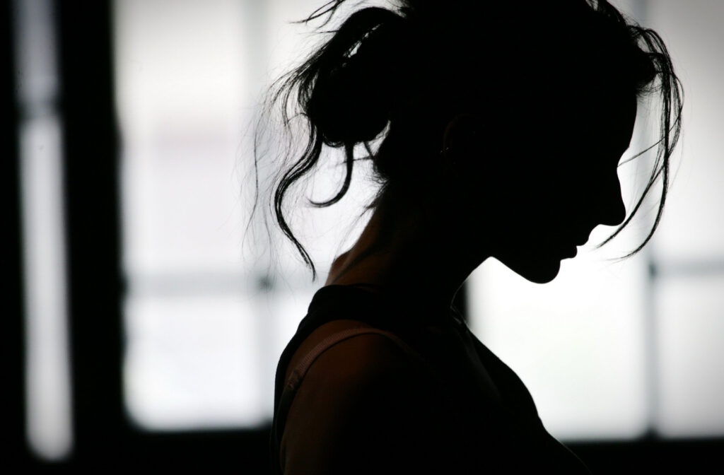 A silhouette of a woman's head dealing with crippling anxiety.