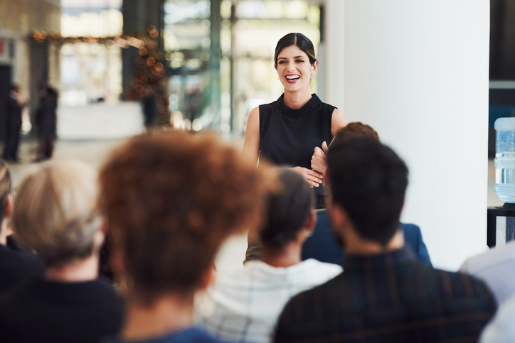 A woman delivers a presentation in an office